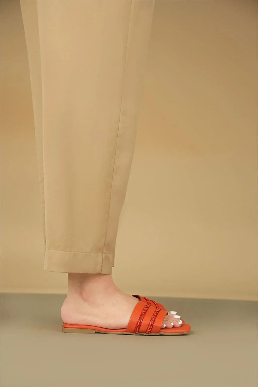 OPIA 5001 ORANGE semi-formal orange flats with diamontees and matte sole worn with beige pants