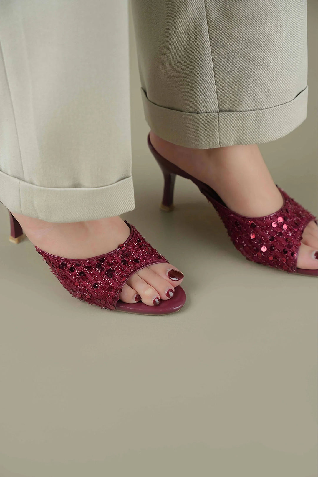 OPIA 9792 MRA maroon sequined slip-on heels on feet with beige pants